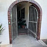 Custom aluminium gate fitted to a brick archway